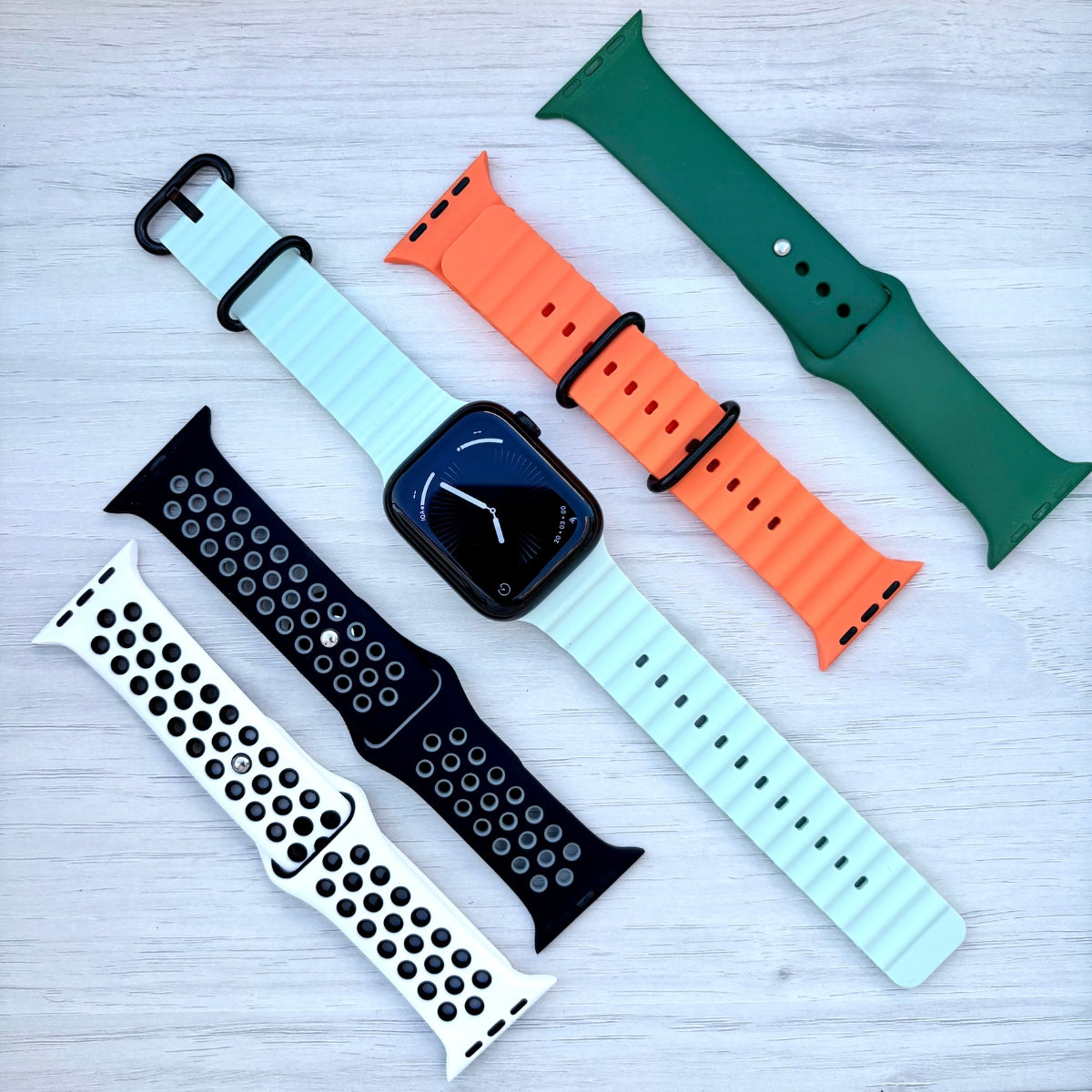 Green silicone Apple Watch bands on wrist, designed for active comfort and all-day wear