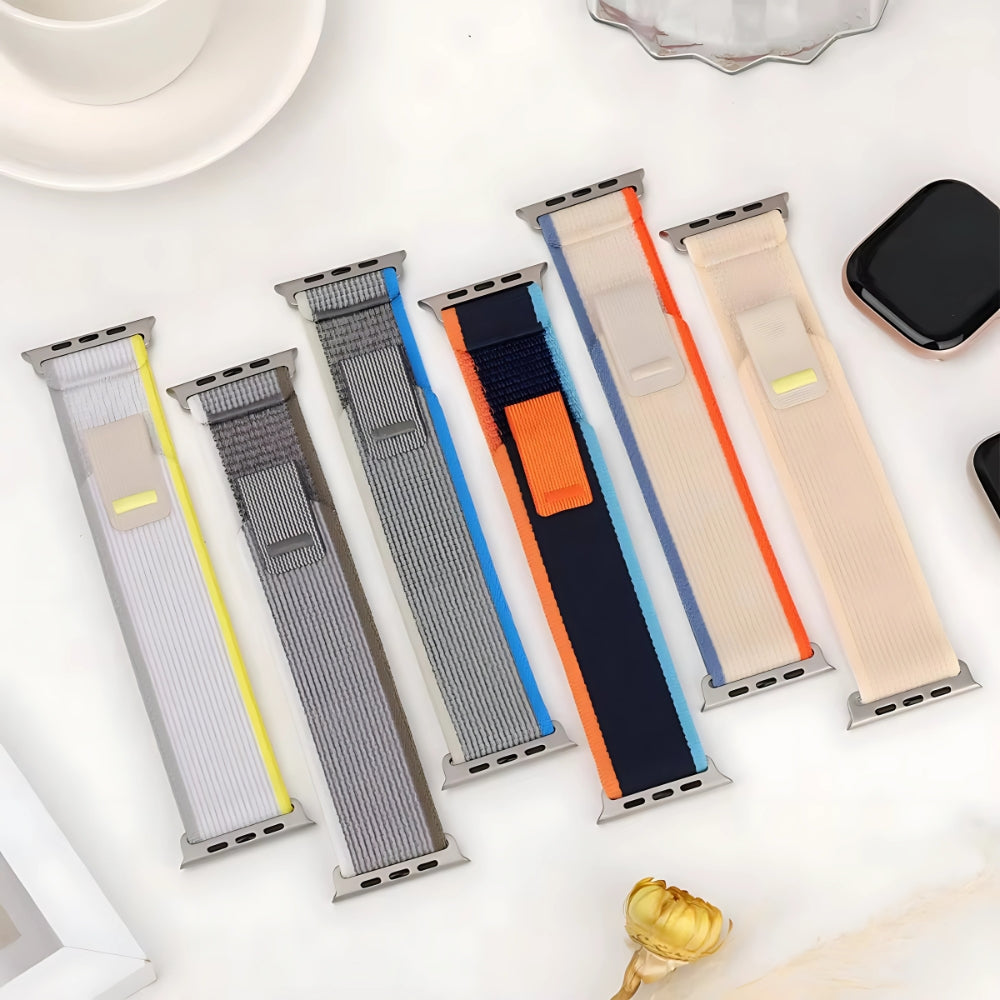 Multiple Trail Loop Apple Watch bands in a variety of colors including Yellow Beige, Blue Gray, Black Gray, Orange Beige, Gray White, Blue Black, Army Green, Orange, and Sea Salt—shown together to highlight the breathable nylon design and sporty, stretchable fit for Apple Watch Ultra and Series 9/8/7.