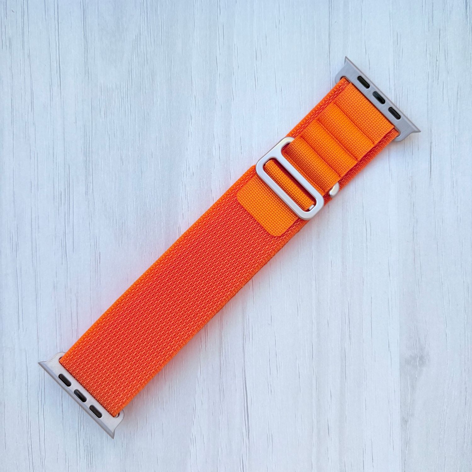 Orange Alpine Loop band with silver connectors