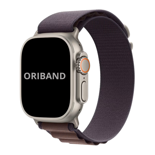 Face view Apple watch Ultra 2 with indigo Alpine Loop band and silver buckle on a transparent background.