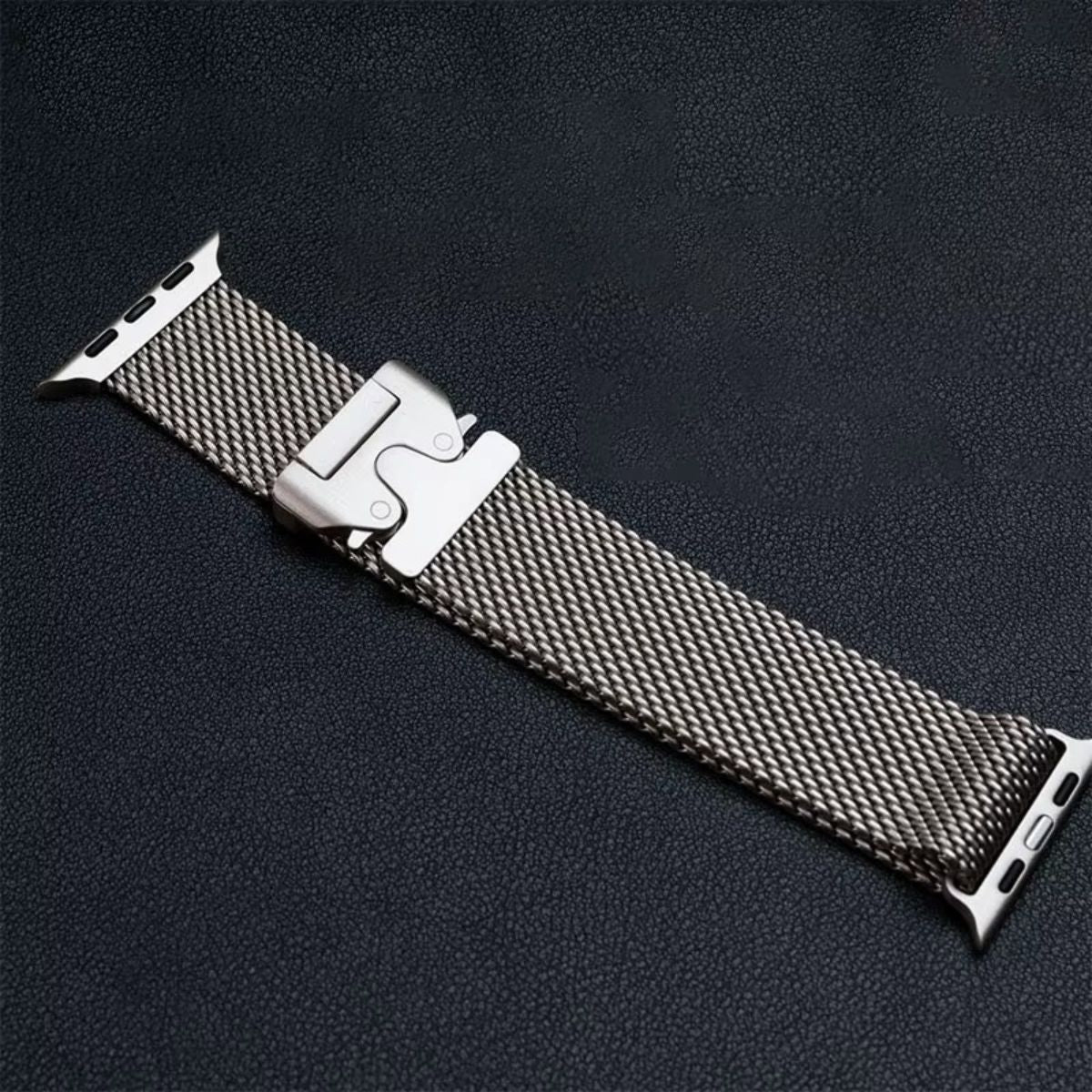 A close-up of a silver Milanese loop Apple Watch band, showing its precision-crafted stainless steel weave and durable parachute buckle