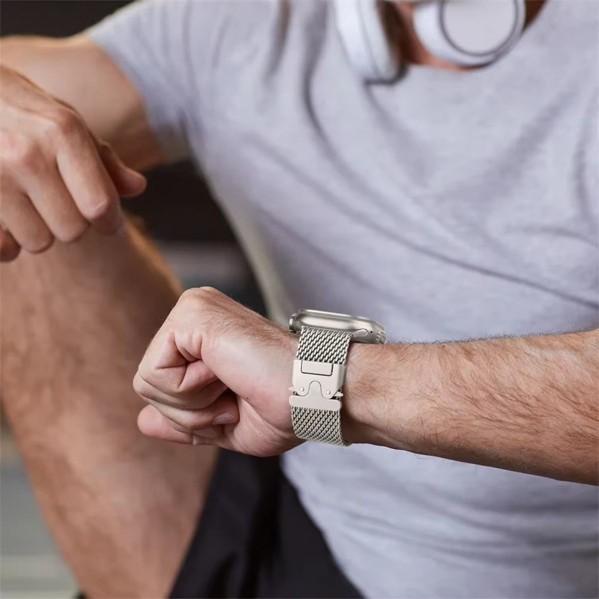 A person wearing a titanium-colored Milanese loop Apple Watch band, emphasizing its stylish and secure fit for various wrist sizes