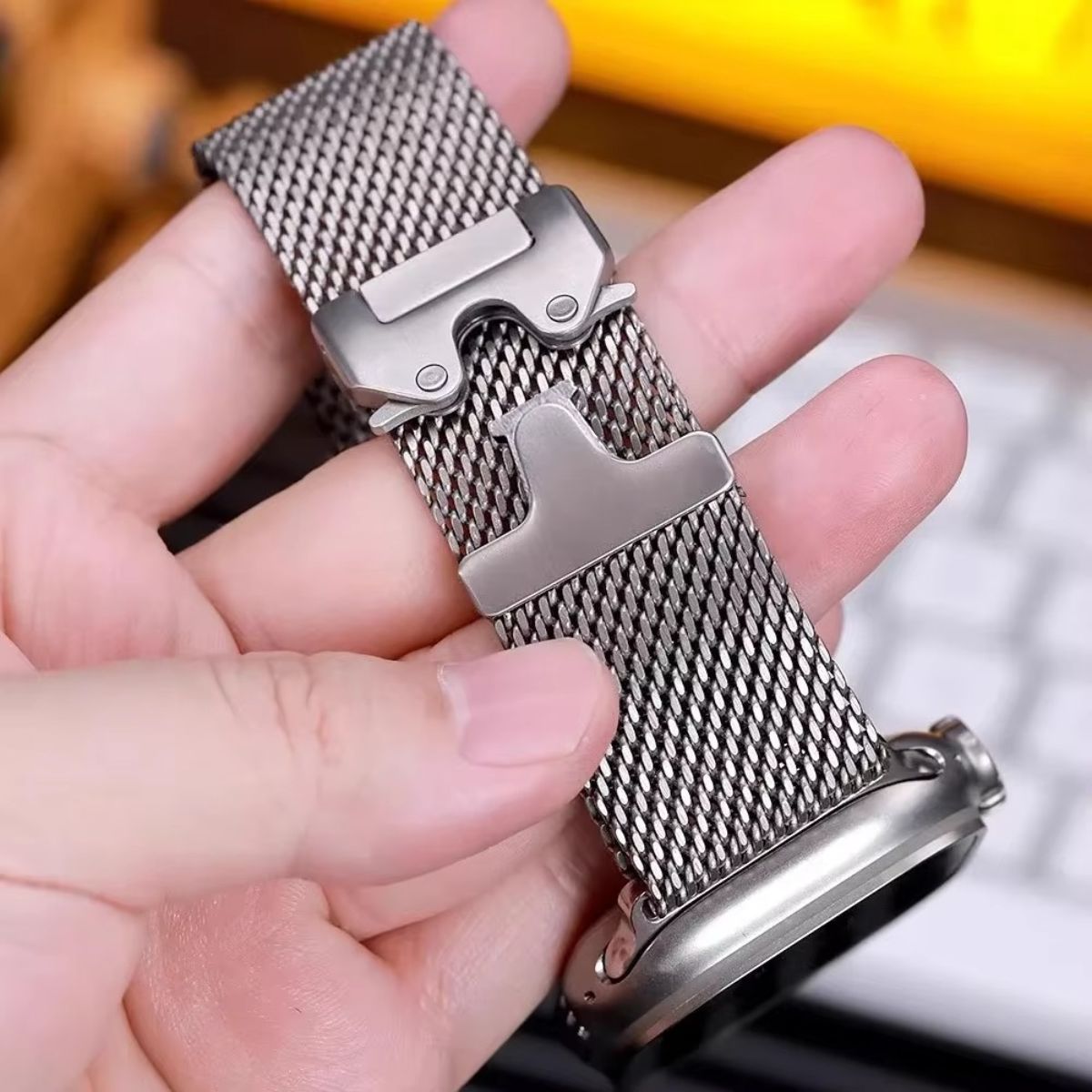 A close-up of an Apple Watch Ultra 2 with a Milanese loop band, displaying its stylish, breathable, and adjustable stainless steel weave