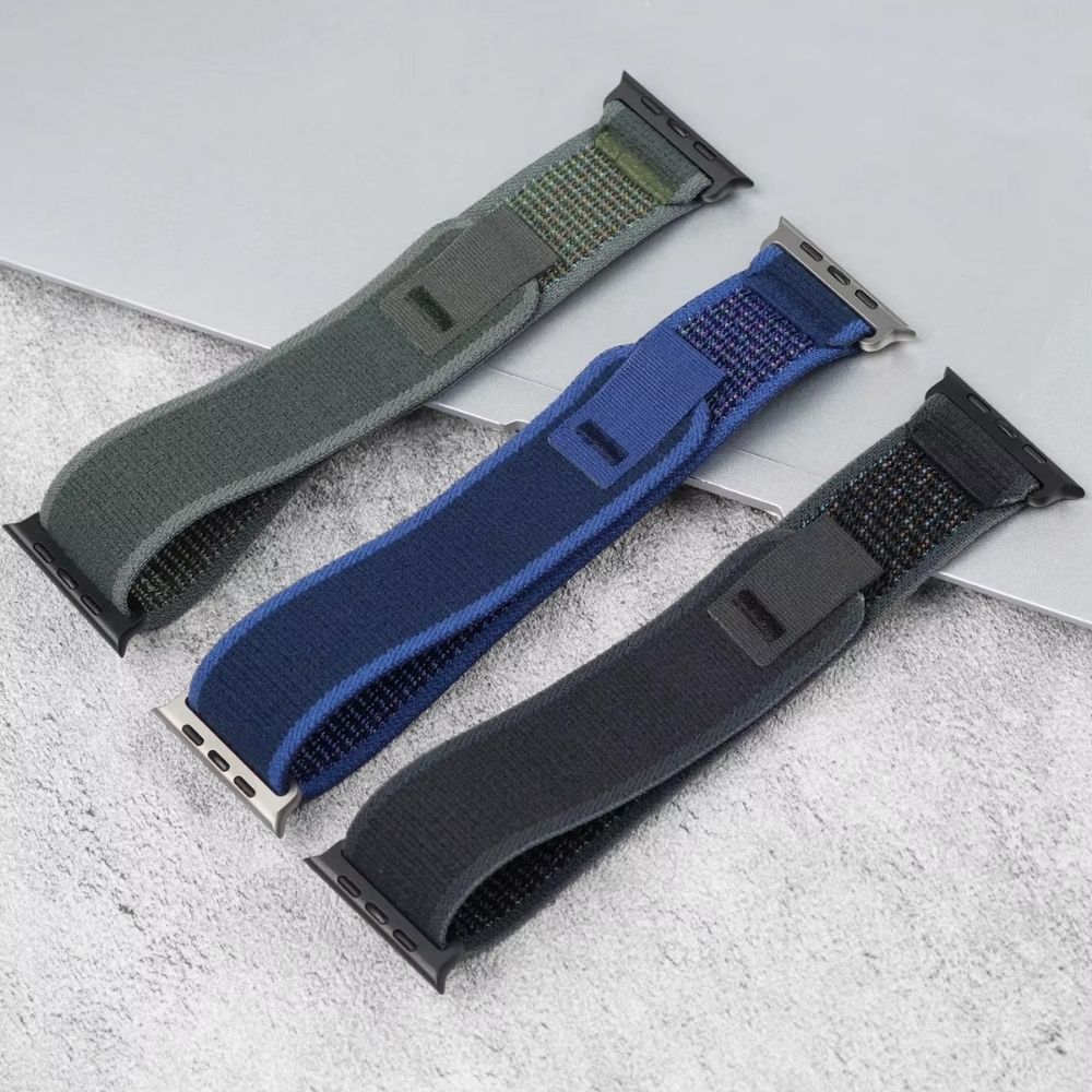 Trail Loop Apple Watch bands in Black, Green, and Blue – rugged nylon straps with black and silver connectors, shown side by side for color comparison and style versatility.