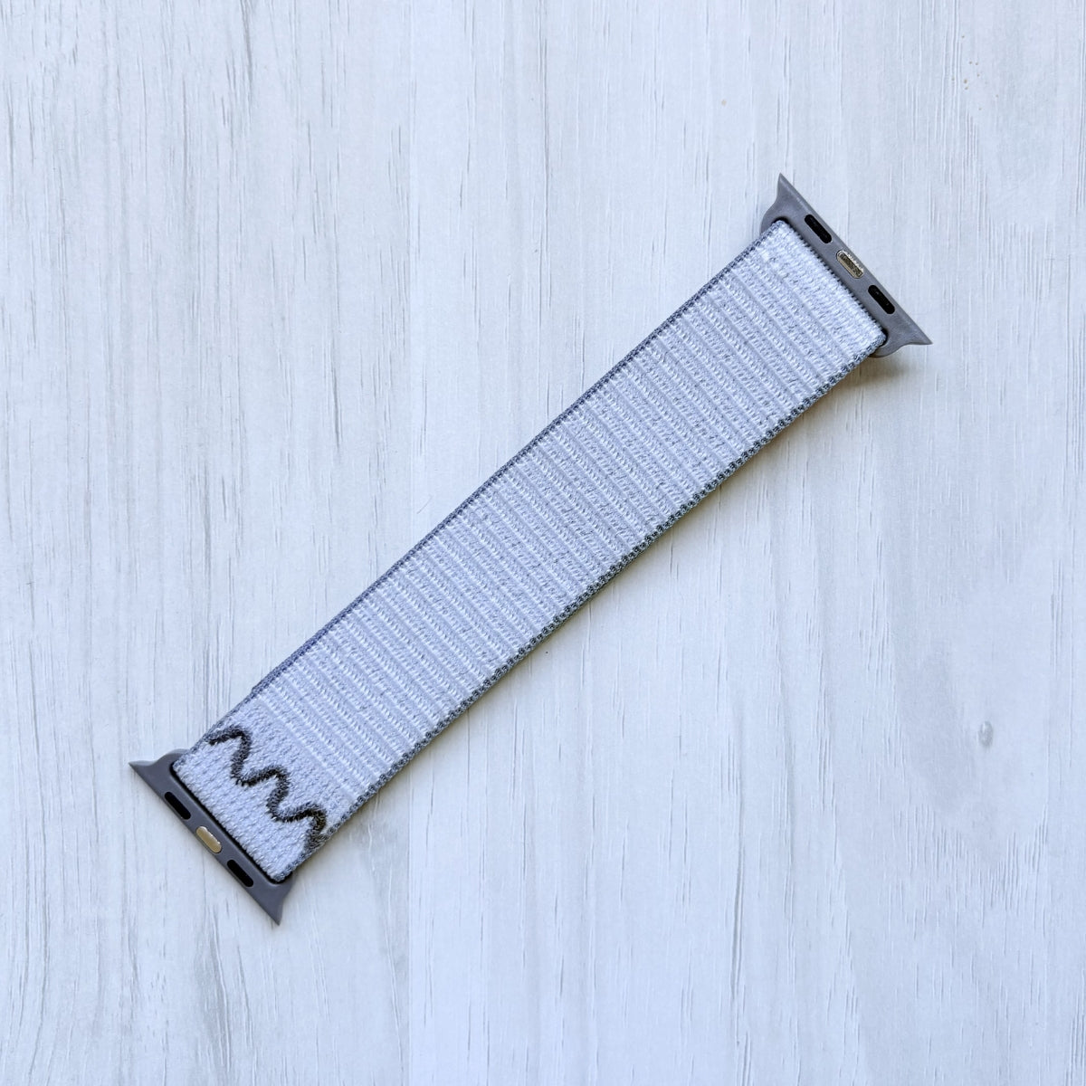 Veiled Grey Woven Nike sport loop band on a white background, back side.