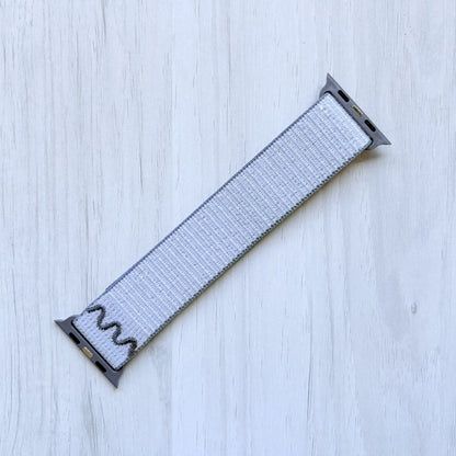 Veiled Grey Woven Nike sport loop band on a white background, back side.