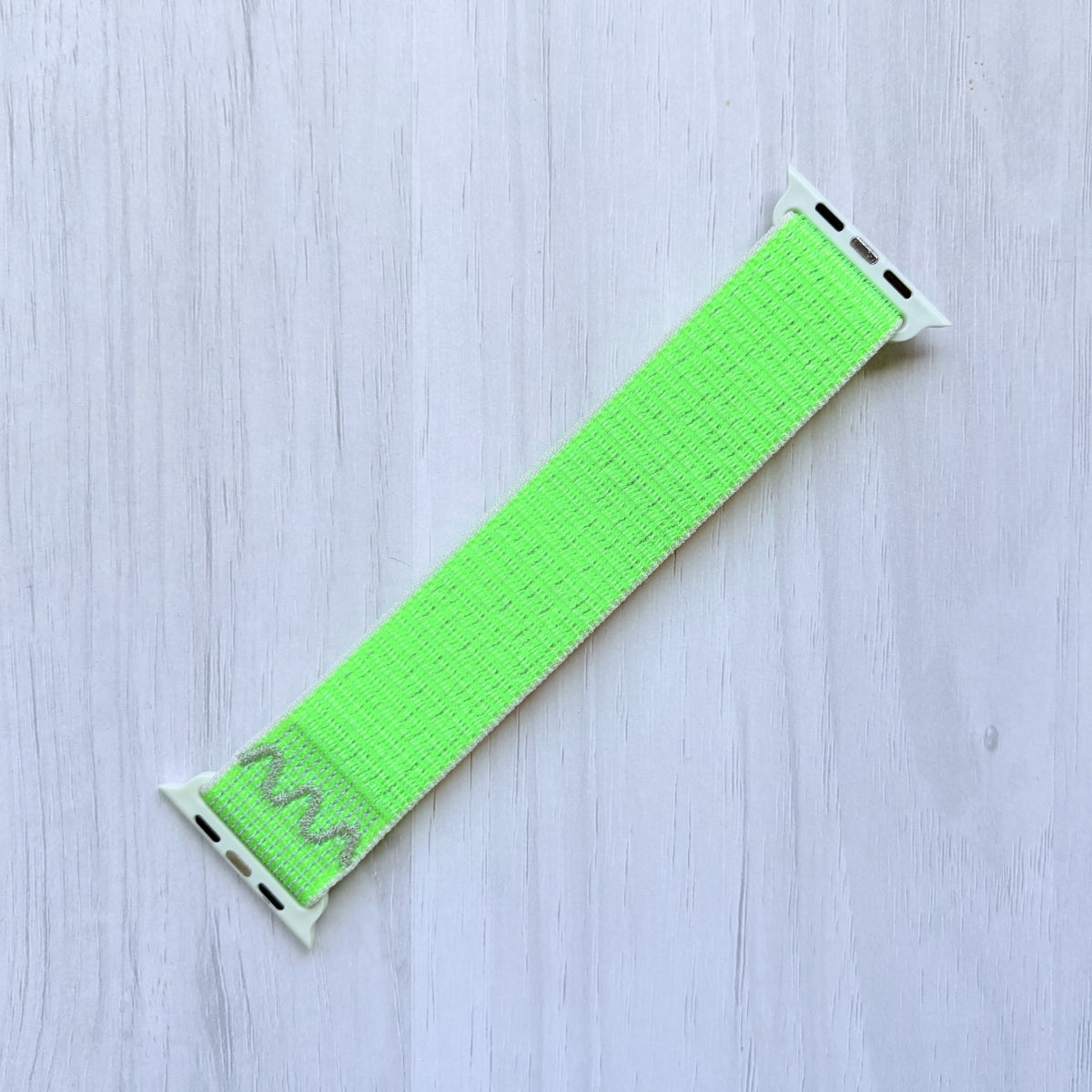 Volt Splash Apple watch strap on a light wooden surface, Back side