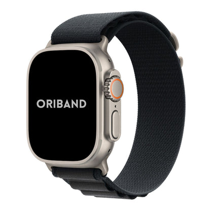 Titanium Apple Watch Ultra with a Black Alpine Loop woven band on a white background, featuring the brand 'Oriband'.