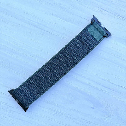 Dark green Alpine loop Band for apple watch with Black finish on a white wooden background back view