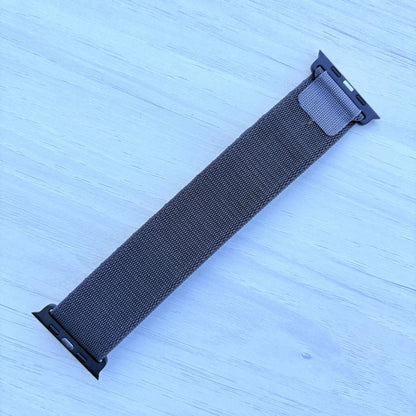 Dark gray Alpine loop Band for apple watch with Black finish on a white wooden background back view