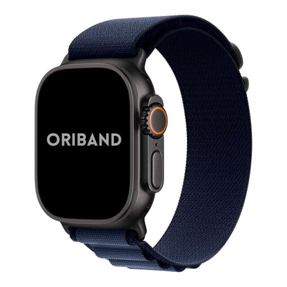 Apple Watch Ultra in black finish with nylon alpine loop band in navy blue on a white background, featuring the brand 'Oriband'.