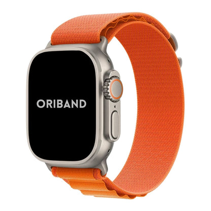 Apple Watch Ultra with a sleek titanium case paired with a Orange Alpine Loop band in a white background, showcasing a rugged, durable design perfect for outdoor and everyday wear.