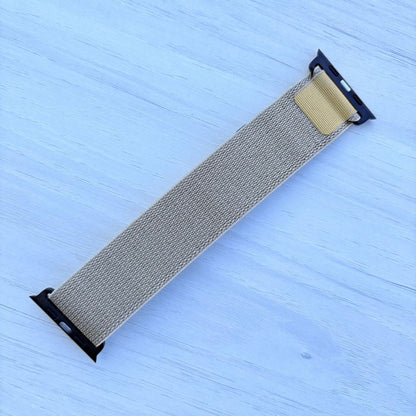 Tan Alpine loop Band for apple watch with Black finish on a white wooden background back view