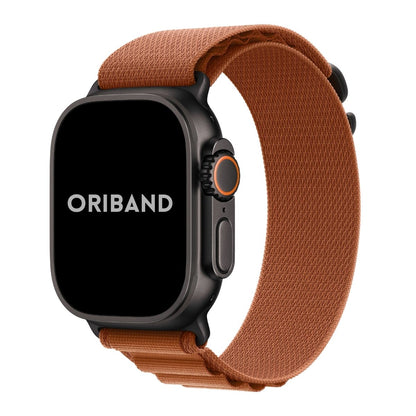 Black Apple Watch Ultra 3 with a terra cotta alpine loop band on a white background, featuring the brand 'Oriband'.