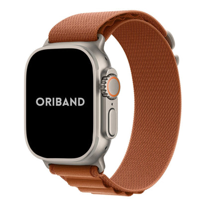Apple Watch Ultra with a sleek titanium case paired with a Terra cotta Alpine Loop band front view.