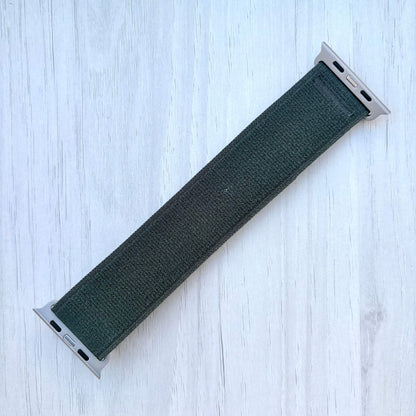 Green Trail loop band with silver finish on a light wooden surface