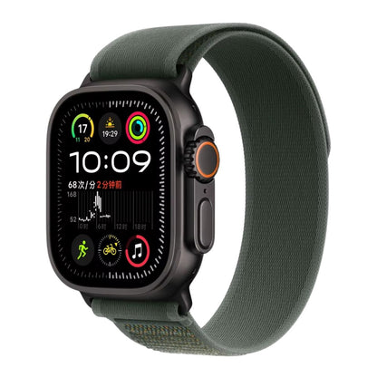 Blakc Apple Watch Ultra with a Green Trail loop band on a white background