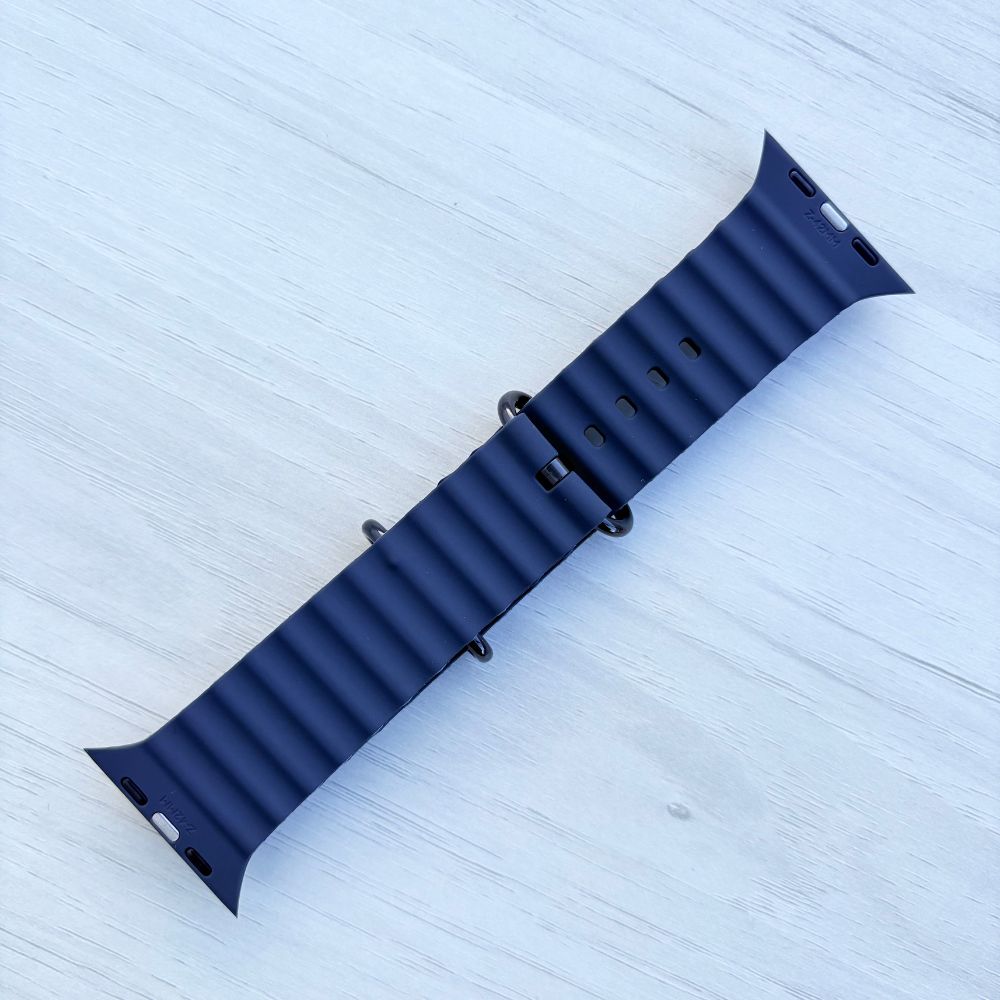 Ocean Band for Apple Watch in Navy with Black Buckle, Back View on Light Wooden Surface