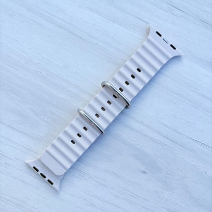 Ocean Band for Apple Watch in Starlight with Silver Buckle, Front View on Light Wooden Surface