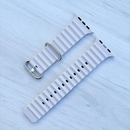 Ocean Band for Apple Watch in Starlight with Silver Buckle, on Light Wooden Surface