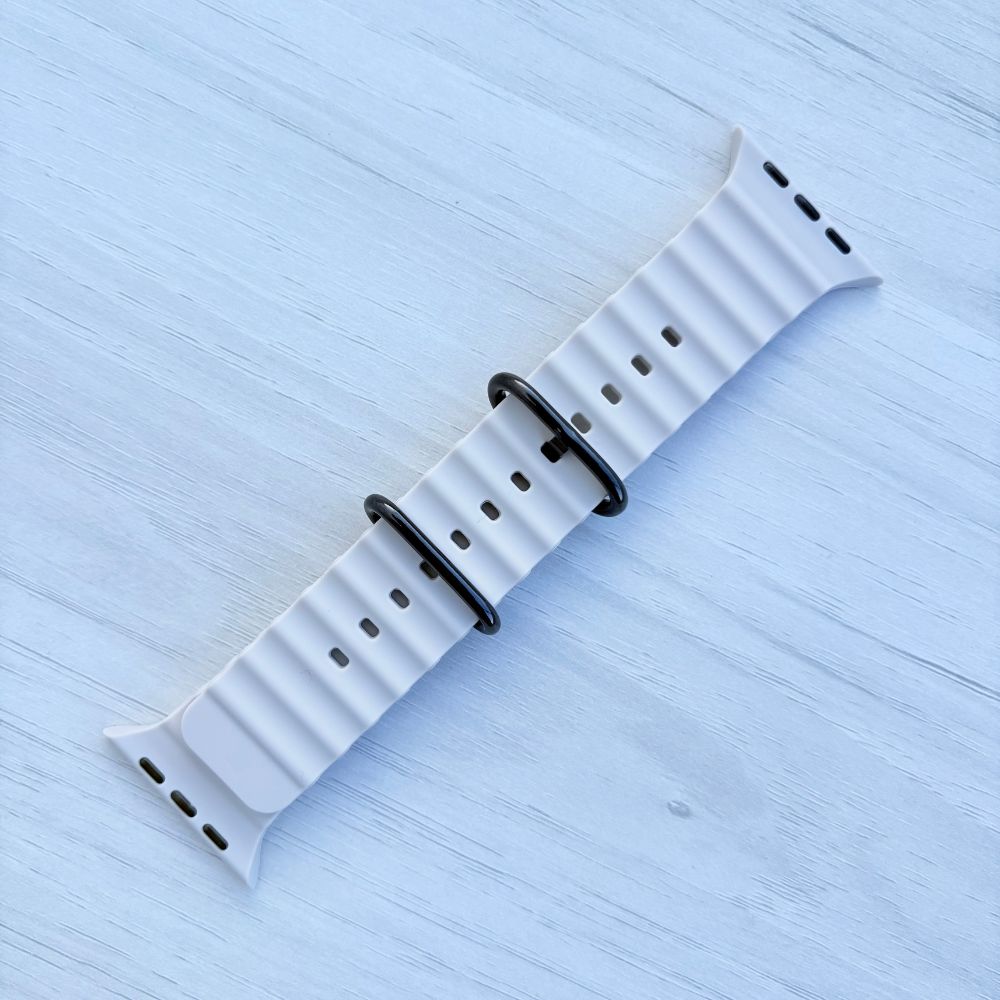 Ocean Band for Apple Watch in Starlight with Black Buckle, Front View on Light Wooden Surface