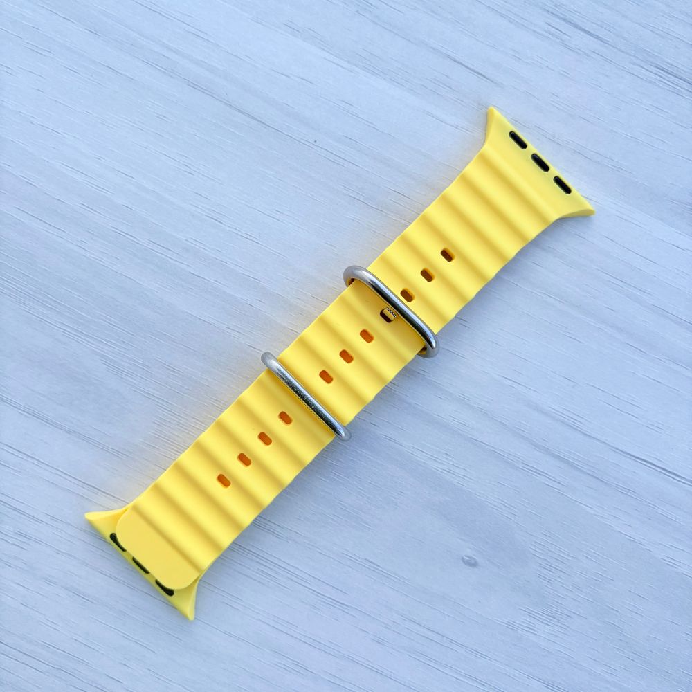 Ocean Band for Apple Watch in Yellow with Silver Buckle, Front View on Light Wooden Surface