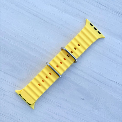 Ocean Band for Apple Watch in Yellow with Silver Buckle, Front View on Light Wooden Surface