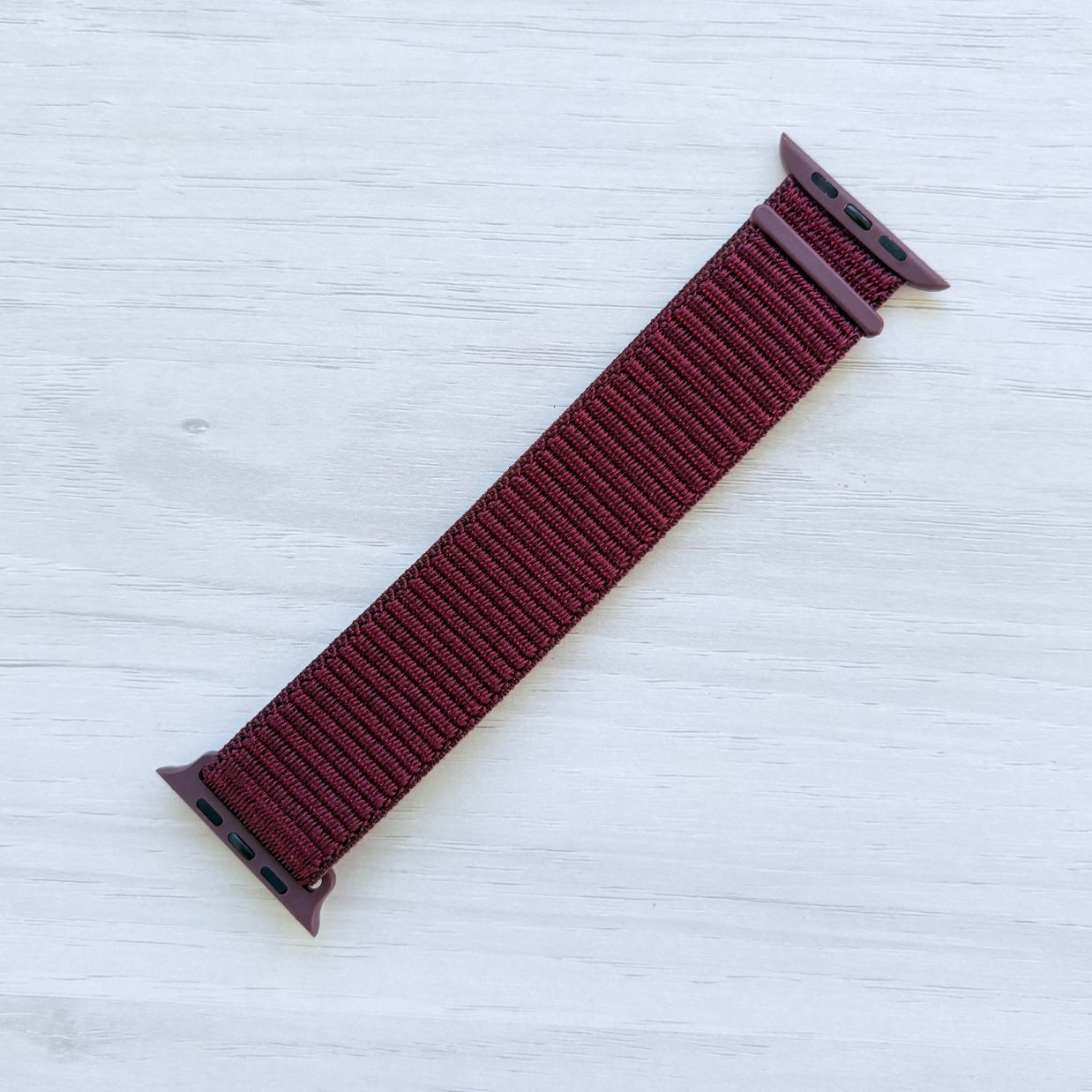 Plum Sport Loop Apple Watch Band with woven nylon design, front view.