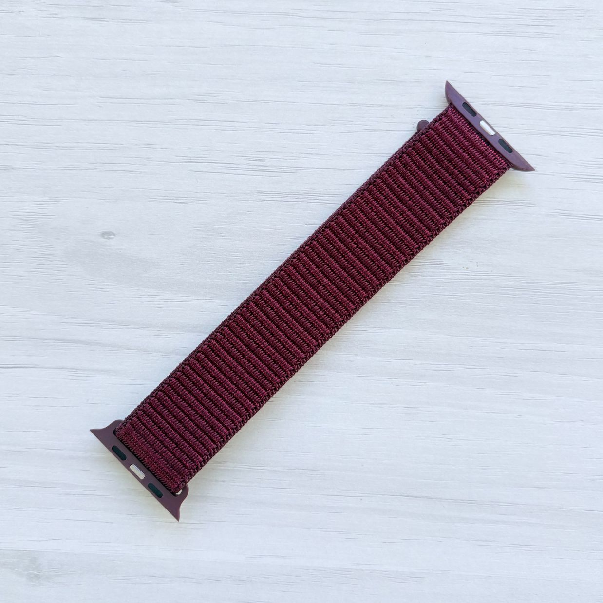 Plum Sport Loop Apple Watch Band with woven nylon design, back view.